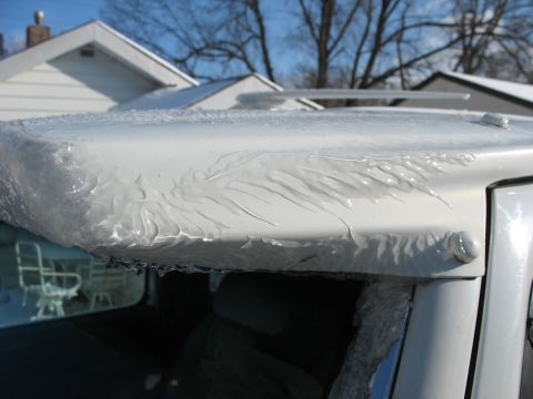 1995 Ford C-350 (Centurion Conversions) - Ice accumulation on the roof edge of a vehicle during winter conditions.