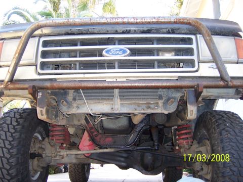 1991 Ford Bronco - The front grille and bumper assembly of a Ford truck, showing off-road modifications and a timestamp.