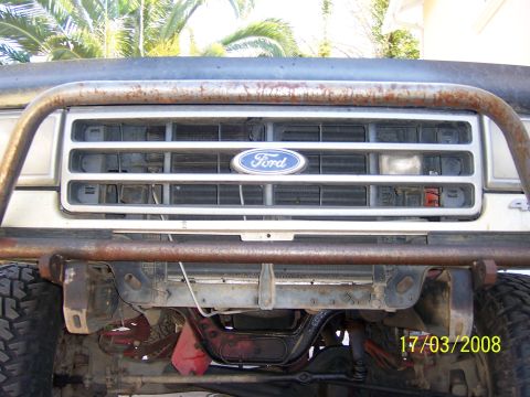 1991 Ford Bronco - Close-up of a Ford Bronco's front end, showing the grille and a heavily modified bumper.