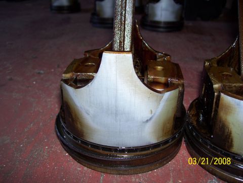 1978 Ford Bronco - Two engine pistons show significant wear and damage, indicating a mechanical failure.