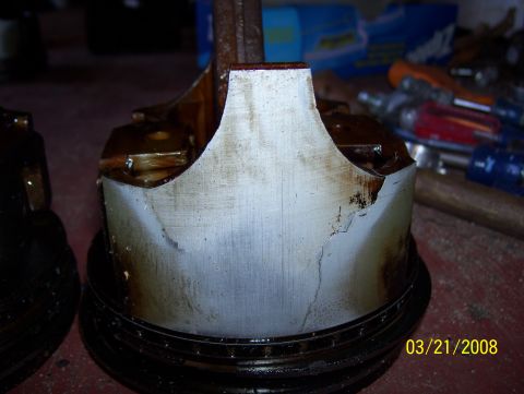 1978 Ford Bronco - A damaged piston shows significant wear and tear, indicating mechanical failure.