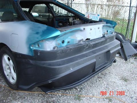 1993 Ford Probe - The rear of a car is shown with its bumper removed, revealing bodywork and primer.