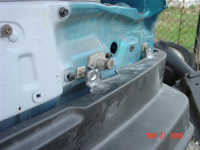 Close-up of car part with blue paint and black bumper, timestamp MAR 21 2008
