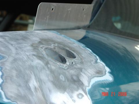 1993 Ford Probe - Car bodywork undergoing repair, with a metal spoiler attached and visible body filler.