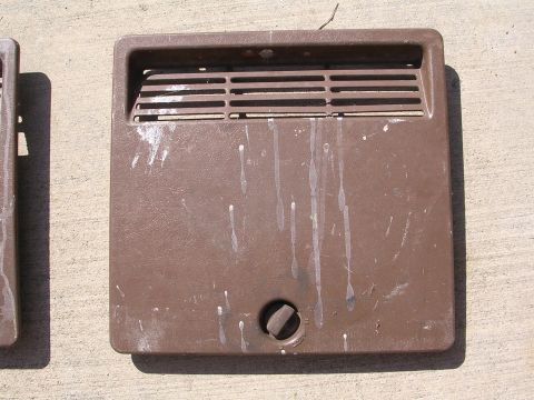 1983 Ferrari Enzo - Brown plastic vent cover with horizontal slats and a central knob, showing white drips.