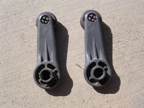 1983 Ferrari Enzo - Two gray plastic window crank handles are shown lying on a concrete surface. These appear to be aftermarket or generic parts.