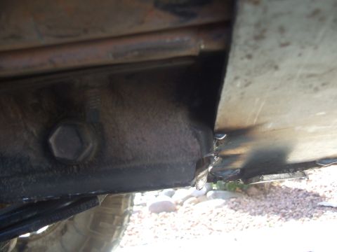 1994 Jeep Cherokee - Underbody view of a vehicle, focusing on a protective metal plate and suspension parts.