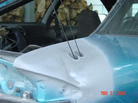 1993 Ford Probe - The front end of a car is shown with primer on the hood, and the interior is visible through the windshield.