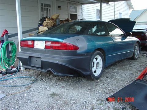 1993 Ford Probe - This 1993 Ford Probe is seen from the rear with its hood open, parked on a gravel surface.