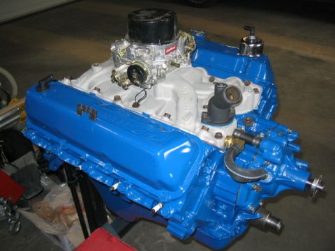 1979 Ford F-150 - A blue Ford V8 engine with a chrome air cleaner and carburetor is displayed.