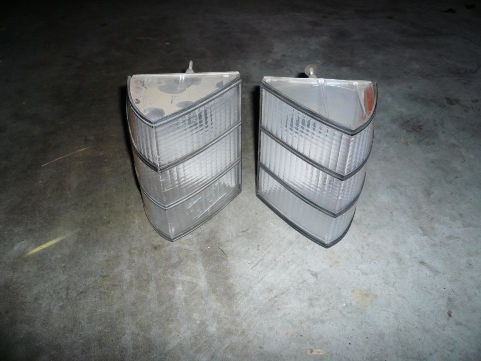 pair of clear plastic car tail lights with black trim