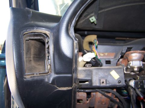 1996 Ford Probe - Interior view of a car's dashboard showing wiring and an open compartment.
