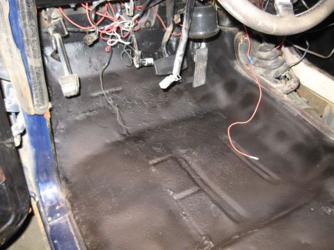 1978 Ford Bronco - Vehicle interior floor showing pedals, wiring, and black undercoating.