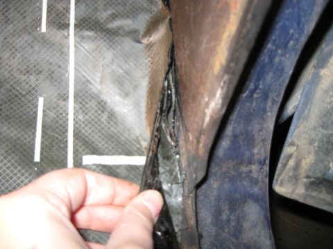 1978 Ford Bronco - Damaged material is being pulled from the vehicle's frame, revealing rust and blue paint.