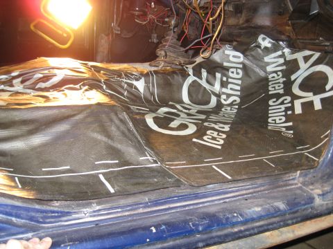 1978 Ford Bronco - The interior floor of a vehicle is covered with black insulation material, showing the brand name 'GRACE Ice & Water Shield'.
