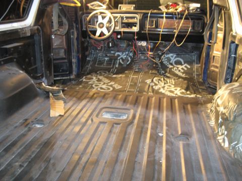 1978 Ford Bronco - The interior of a vehicle is shown with soundproofing material laid on the floor and various wires exposed, suggesting ongoing work.