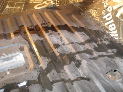 1978 Ford Bronco - Corrugated metal surface showing signs of liquid spills and residue.