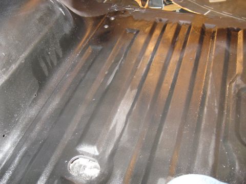 1978 Ford Bronco - The interior floor of a vehicle shows ribbed metal construction with signs of wear and a circular opening.