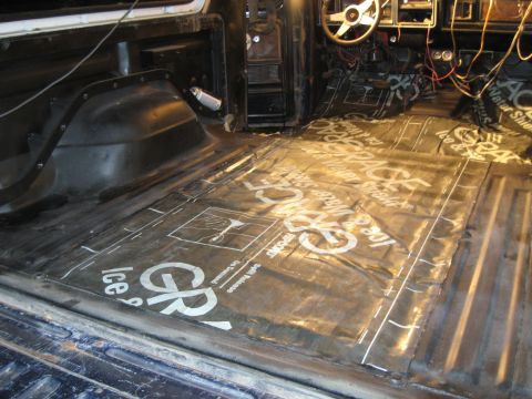 1978 Ford Bronco - The interior of a vehicle is being prepared for sound deadening material installation on the floor.