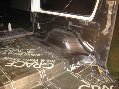1978 Ford Bronco - Sound deadening material is being applied to the cargo area of a vehicle.