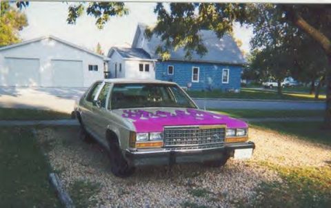 1987 Ford Crown Victoria LTD - This 1987 Ford Crown Victoria LTD features a striking pink hood against its silver body.