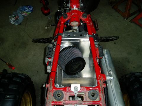 2000 Ford E350 - Close-up of a vehicle's internal components, including a red frame and air filter.