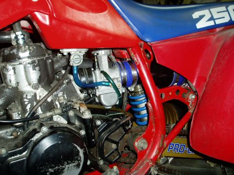 2000 Ford E350 - The image shows a detailed view of a motorcycle's engine, carburetor, and suspension components.