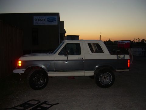 1991 Ford Bronco - Side view of a two-tone 1991 Ford Bronco during sunset.