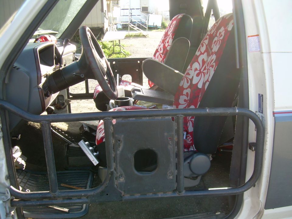 1991 Ford Bronco interior with aftermarket roll cage and floral seat covers