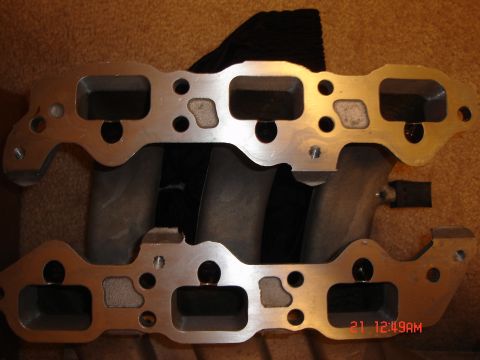 1993 Ford Probe - Close-up of an aluminum intake manifold, a component of a vehicle's engine.