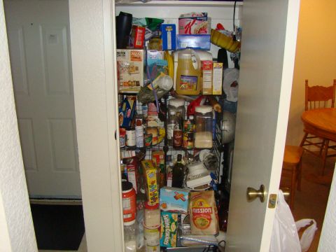 1989 Ford Bronco - A full pantry with shelves organized with various food items and kitchen supplies.