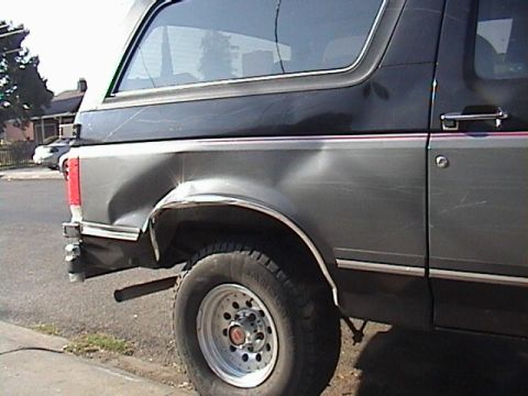 1990 Ford Bronco - This Ford Bronco shows substantial damage to its rear passenger side panel.