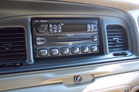2001 Ford Crown Victoria - Interior view of a 2001 Ford Crown Victoria, focusing on the dashboard's radio and air vents.