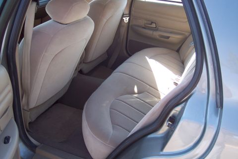 2001 Ford Crown Victoria - Interior view of the rear seats and door panel of a 2001 Ford Crown Victoria.