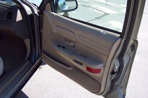 2001 Ford Crown Victoria - Interior view of the driver's side door panel on a 2001 Ford Crown Victoria.