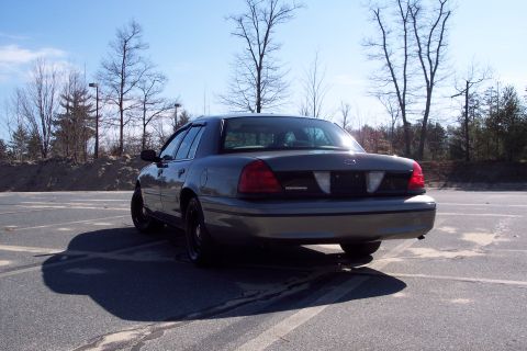 2001 Ford Crown Victoria - Rear view of a 2001 Ford Crown Victoria parked outdoors on a sunny day.