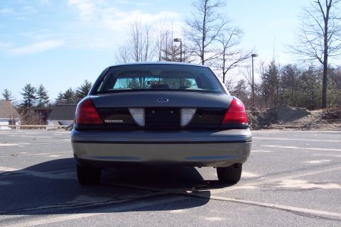 2001 Ford Crown Victoria - The rear of a 2001 Ford Crown Victoria is shown parked in an outdoor lot.