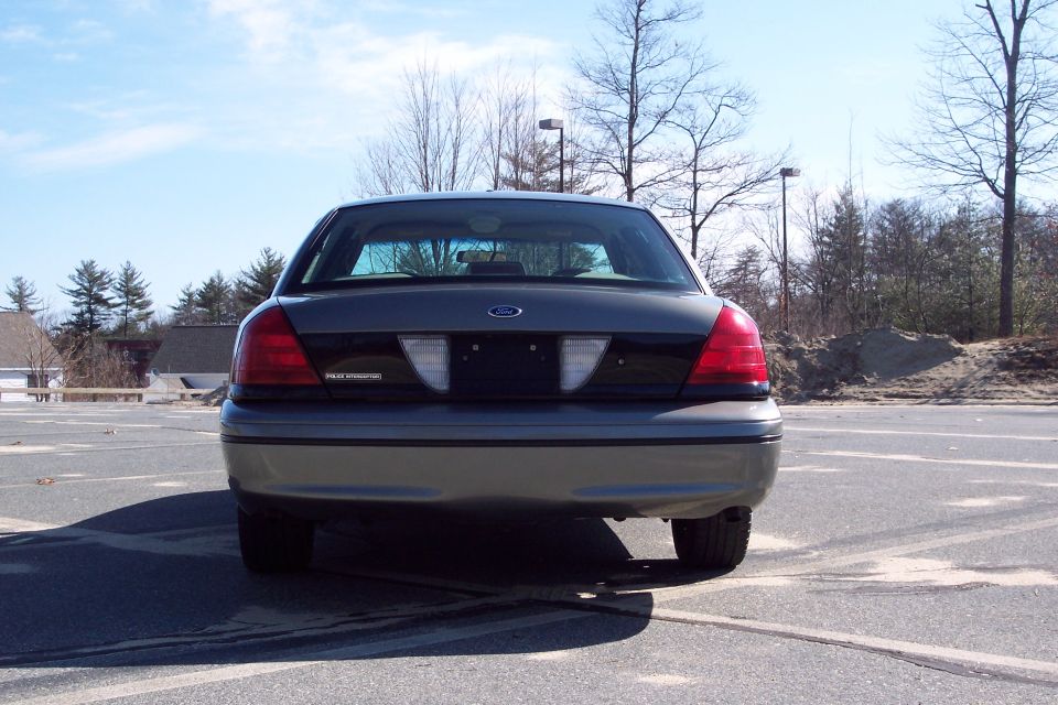 Rear view of a 2001 Ford Crown Victoria, grey with a black trim panel