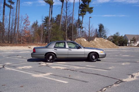 2001 Ford Crown Victoria - A silver 2001 Ford Crown Victoria is parked in a lot on a clear day.