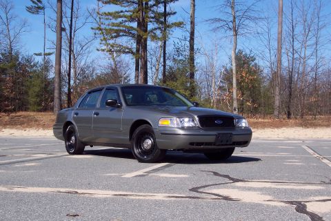 2001 Ford Crown Victoria - A 2001 Ford Crown Victoria is shown from a three-quarter front view, parked outdoors on a paved surface.