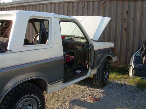 1991 Ford Bronco - This 1991 Ford Bronco is shown with its doors removed, revealing a roll cage inside.