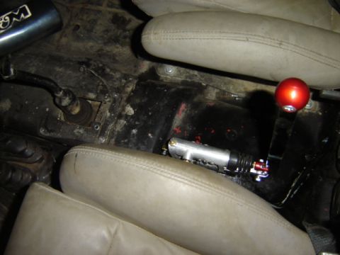 1992 Ford Bronco - Aftermarket shifter and clutch cylinder visible in the vehicle's interior.