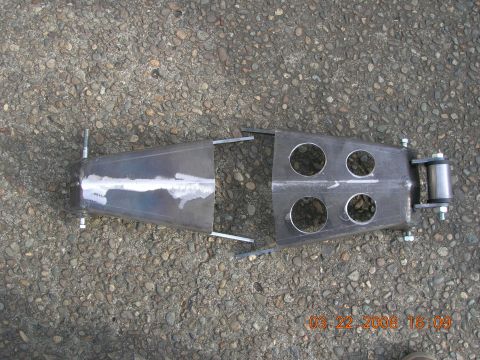 1996 Ford Bronco - Custom fabricated metal suspension part with multiple holes and a roller.