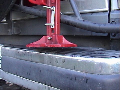 1990 Ford Bronco - A Hi-Lift jack is mounted to the rear bumper of an off-road vehicle.