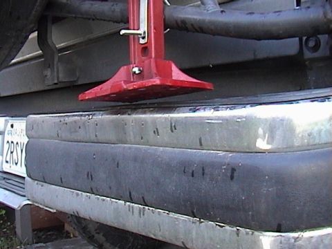 1990 Ford Bronco - A red hi-lift jack is mounted to the rear bumper of a 1990 Ford Bronco.