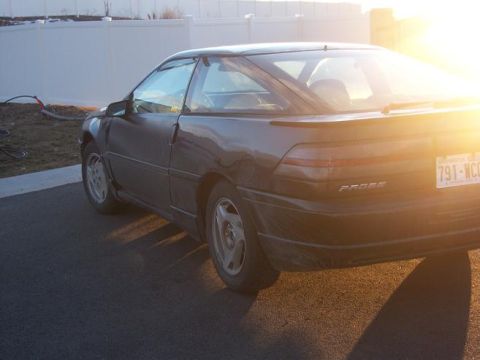 1990 Ford Probe - Rear view of a 1990 Ford Probe, parked on asphalt during sunset.