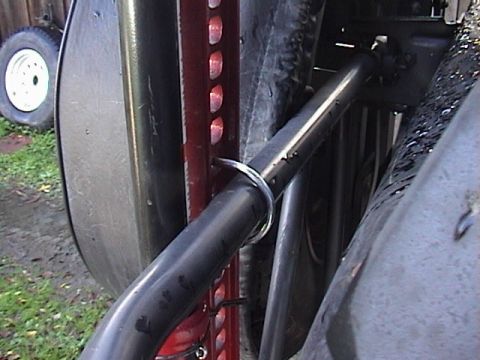 1990 Ford Bronco - Close-up view of a Hi-Lift jack mount attached to a vehicle's frame or body panel.