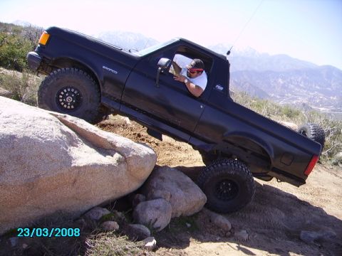 1990 Ford Bronco - This black 1990 Ford Bronco navigates a rocky off-road course with a driver behind the wheel.
