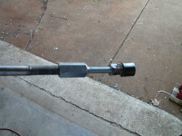 That second nut gives you something to thread your slide hammer adapter into, and the slide hammer will pull it right out.  It took three hits to remove it.
