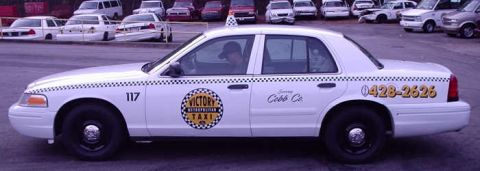 1996 Ford Crown Victoria - White 1996 Ford Crown Victoria taxi cab with "Victory Taxi" and Cobb Co. markings.